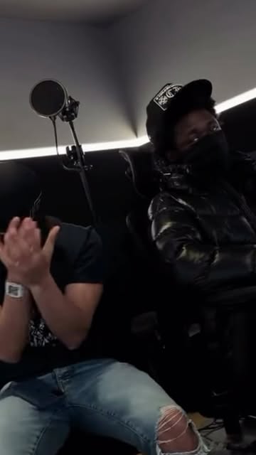 Two performers beside a studio microphone in a RapUKHub reel